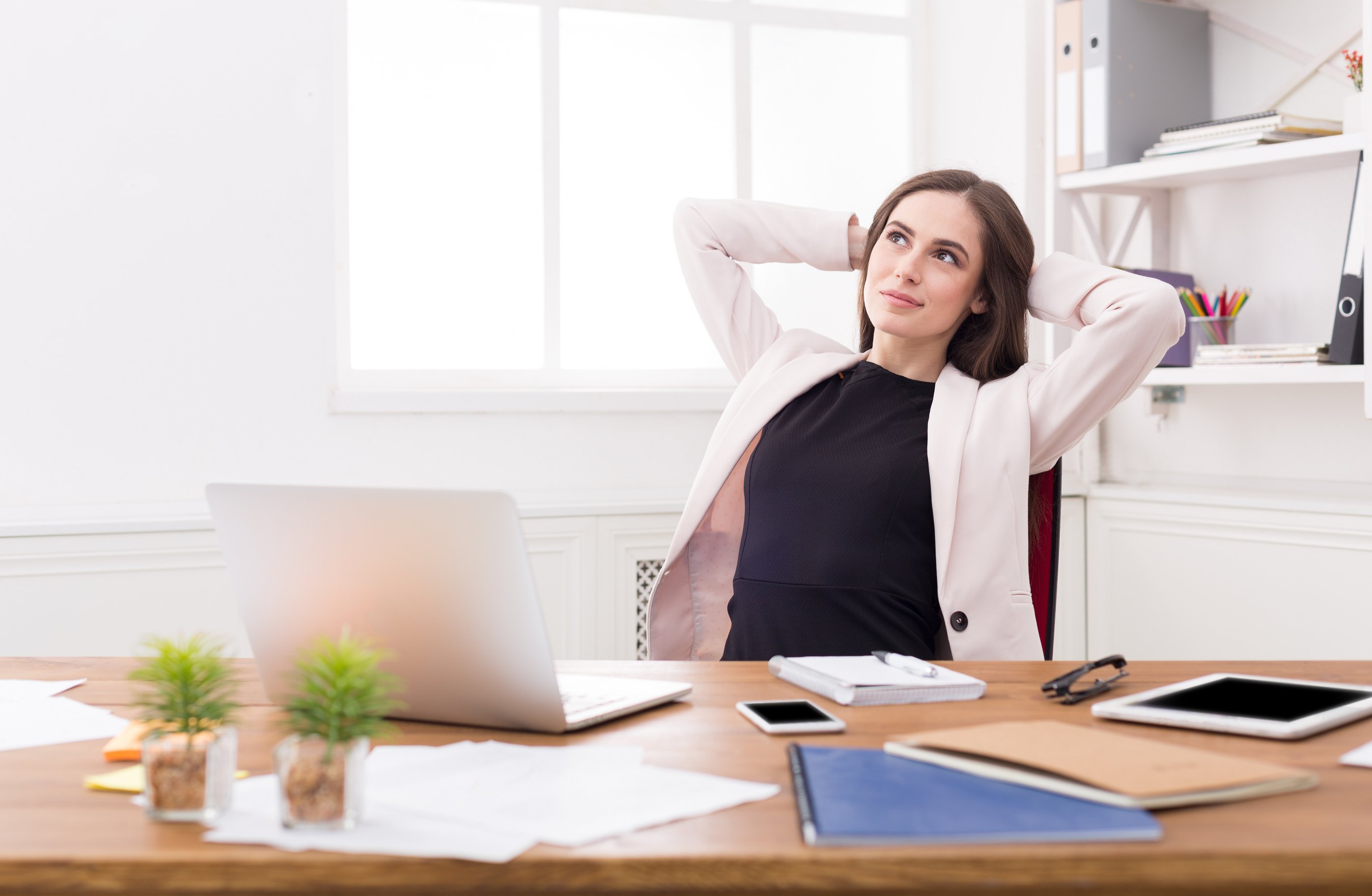 Business woman dreaming about vacation